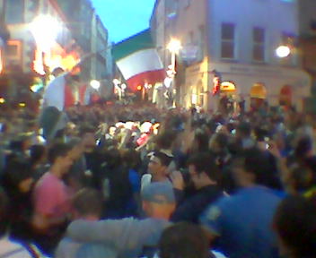 several hundred italian fans partying with flags and songs
