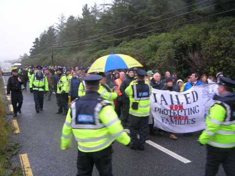 Police escort along the newly re-opened public road