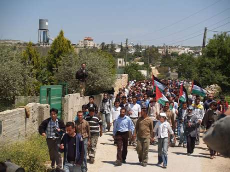 Non-violent demonstrators march to the Apartheid Wall