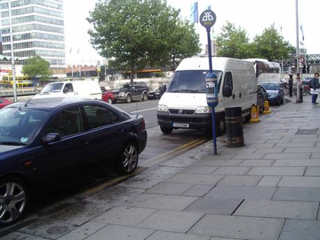 Garda Van and Cars parked at bus stop all afternoon