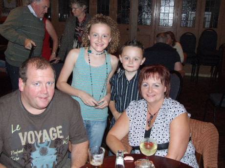 Lauren Leonard and her brother Andrew from Andersonstown, Belfast, stand behind their mum and dad, Eileen and Tony, at last night's function in The Strand Hotel, Omeath.