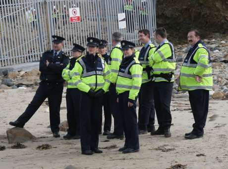 Garda look on as protesters assert their rights to access the water.