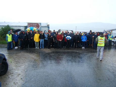 damp walkers pose outside Shell's compound in Rossport this morning