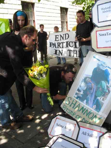 Damien laying flowers on shrine to the Iraqi dead