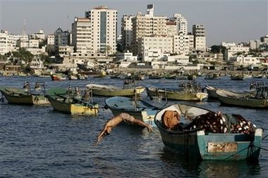 Port of Gaza has been closed off for 42 years - A Palestinian youth dives into the sea from a fishing boat