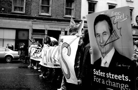 Marchers hold a picture of politician Enda Kenny