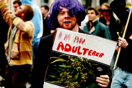 A pro cannabis marcher holds a sign