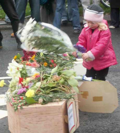 A child lays flowers