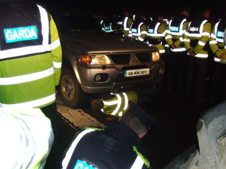 Police remove cars using a tractor ...