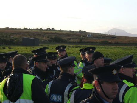 A truck carrying materials is blocked by a small group (background).