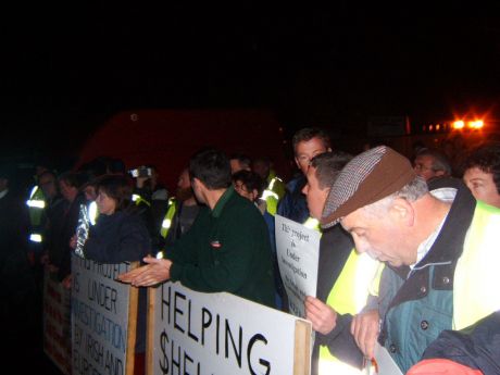 The picket re-tightens in front of the gates.