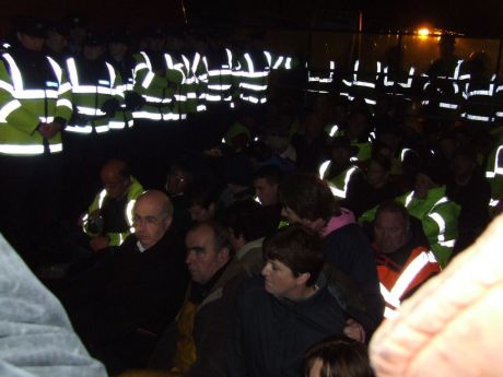 Protesters sit down.